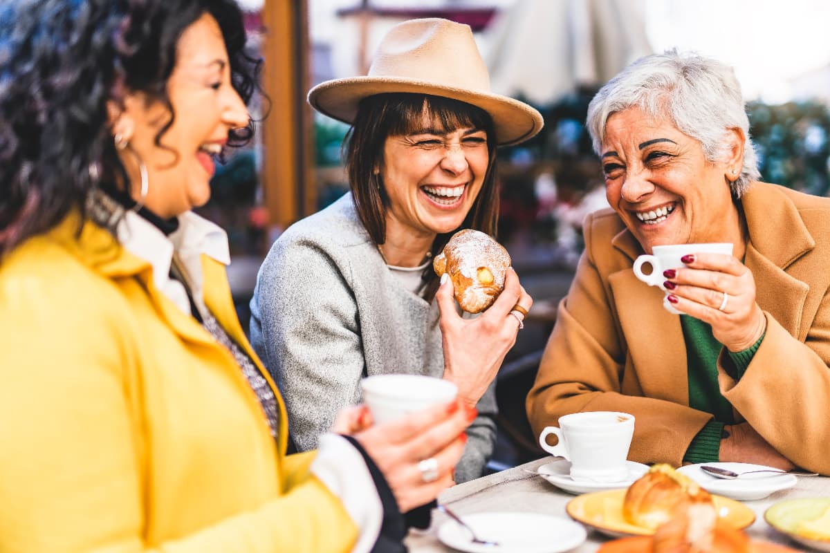 Women drinking coffee and laughing
